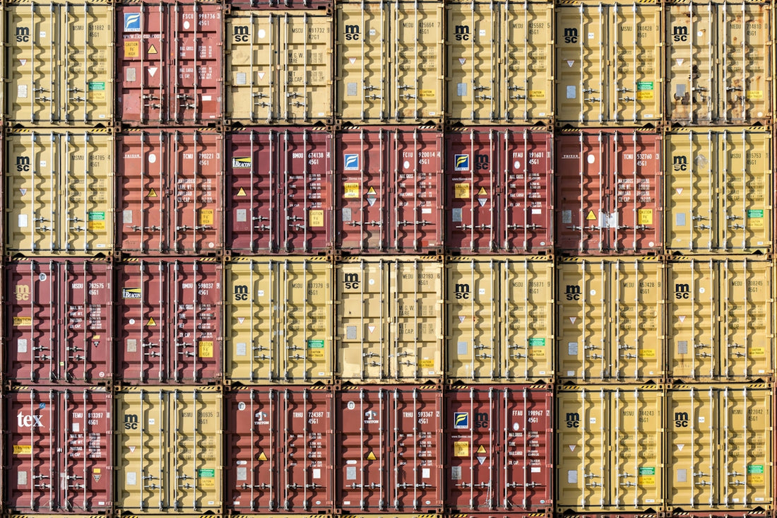 a bunch of cargo containers stacked on top of each other