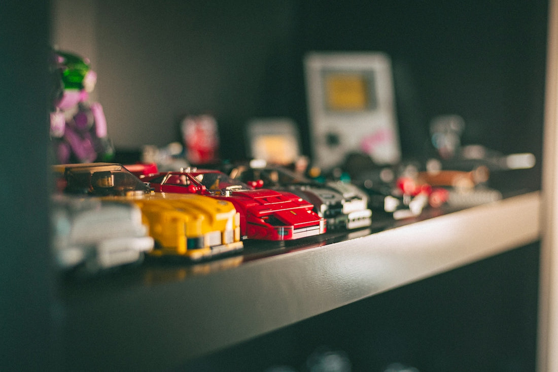 Row of colorful toy cars on a dark display shelf